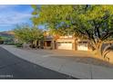 Stunning home with a desert landscape, two-car garage, and stone accents at 16401 S 29Th Ave, Phoenix, AZ 85045