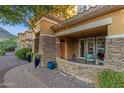 Inviting covered front porch with stone accents and stylish seating at 16401 S 29Th Ave, Phoenix, AZ 85045
