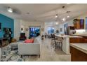 Open-concept living area featuring stylish furniture, a bright accent wall, and sliding doors to outdoor patio at 1654 E Jardin Pl, Casa Grande, AZ 85122