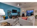 Comfortable living room with modern decor, including cozy seating, a large TV, and a stylish rug at 1654 E Jardin Pl, Casa Grande, AZ 85122
