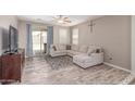 Comfortable living room featuring a neutral color palette and wood-look floors at 16954 W Mohave St, Goodyear, AZ 85338