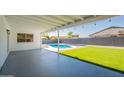 Inviting back patio overlooking a refreshing pool and manicured lawn at 1720 W Behrend Dr, Phoenix, AZ 85027
