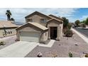 Charming two-story home featuring a neutral color palette, attached garage, and low maintenance desert landscaping at 1758 E San Xavier Dr, Casa Grande, AZ 85122