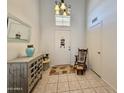 Inviting foyer featuring tile floors, a decorative console table, and a rocking chair at 1758 E San Xavier Dr, Casa Grande, AZ 85122