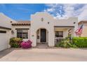 View of the front entrance featuring an arched doorway, desert landscaping, and a tile roof at 19347 E Thornton Rd, Queen Creek, AZ 85142