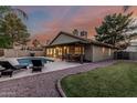 Inviting backyard with a sparkling pool, covered patio, and lush greenery at 19651 N 34Th St, Phoenix, AZ 85050