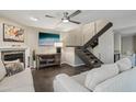 Cozy living room with fireplace, TV, modern stairs, and comfortable seating at 3030 N Hayden Rd # 28, Scottsdale, AZ 85251