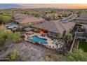 Aerial view of backyard showcasing pool, patio, and desert landscaping with mountain views at 31705 N 128Th Dr, Peoria, AZ 85383