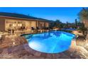 Inviting backyard pool and spa with covered patio, perfect for outdoor relaxation at 31705 N 128Th Dr, Peoria, AZ 85383