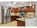 Bright kitchen boasts stainless appliances, tile backsplash, and ample wood cabinet space at 33 W Missouri Ave # 17, Phoenix, AZ 85013