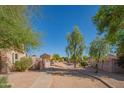 View of a sidewalk pathway in a quiet residential neighborhood, featuring gravel landscaping and desert vegetation at 3365 N Sunaire --, Mesa, AZ 85215
