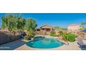 Community swimming pool is surrounded by desert landscaping and a safety fence, perfect for Gathering fun and relaxation at 3365 N Sunaire --, Mesa, AZ 85215