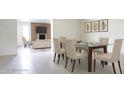 Bright dining room with a glass table set and living room in background at 3556 W Augusta Ave, Phoenix, AZ 85051