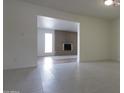 Empty living room featuring a brick fireplace and tile floors at 3556 W Augusta Ave, Phoenix, AZ 85051