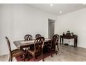 Formal dining room with wood floors, a large wood table and six chairs at 3842 E Bartlett Way, Chandler, AZ 85249