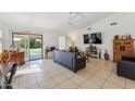 Bright living room with tile flooring and a sliding glass door to backyard at 5263 E Hannibal St, Mesa, AZ 85205
