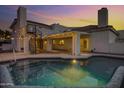 Serene backyard featuring a refreshing pool, covered patio, and spiral staircase, perfect for outdoor living at 5345 E Mclellan Rd # 123, Mesa, AZ 85205