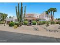 Charming home with lush desert landscaping and a decorative water fountain, showcasing curb appeal at 5345 E Mclellan Rd # 123, Mesa, AZ 85205
