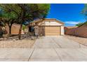 A single-story home boasts a two-car garage, low-maintenance landscaping, and a welcoming entrance at 5675 S 239Th Ln, Buckeye, AZ 85326