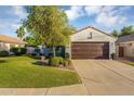 Charming single-Gathering home with mature trees, a well-manicured lawn, and a two-car garage at 5711 E Gable Ave, Mesa, AZ 85206