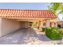 Home exterior featuring a spacious covered carport with terra cotta roof, tidy landscaping, and an inviting entrance at 602 E Colgate Dr, Tempe, AZ 85283