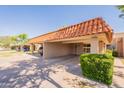 Exterior view featuring a covered carport with a terra cotta roof, tidy landscaping, and an inviting entrance at 602 E Colgate Dr, Tempe, AZ 85283