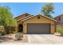 Charming single-story home with a well-manicured lawn, two-car garage and desert landscaping at 7003 S 23Rd Ln, Phoenix, AZ 85041