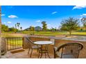 Charming patio with seating area offering a view of the lush green golf course and distant mountains at 7424 N Via Camello Del Norte -- # 185, Scottsdale, AZ 85258