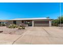 Inviting single-story home with a well-manicured desert front yard, driveway, and attached garage at 772 Leisure World --, Mesa, AZ 85206