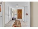 Inviting home hallway features tiled floors, storage closets, and a wooden front door with decorative details at 8202 N 21St Dr # B101, Phoenix, AZ 85021