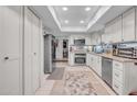Well-lit kitchen with stainless steel appliances, white cabinetry, and tile flooring for a modern, clean aesthetic at 8202 N 21St Dr # B101, Phoenix, AZ 85021