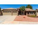 Inviting single-story home boasts stone accents, a two-car garage, and mature landscaping at 8540 W Wescott Dr, Peoria, AZ 85382