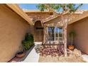 A pathway leads to the ornate front doors framed by stone accents and lush landscaping at 8540 W Wescott Dr, Peoria, AZ 85382