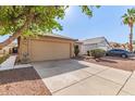 Charming single story home showcasing a two-car garage and low maintenance desert landscaping at 8566 N 110Th Ave, Peoria, AZ 85345