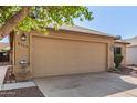 Charming single story home showcasing a two-car garage and low maintenance desert landscaping at 8566 N 110Th Ave, Peoria, AZ 85345