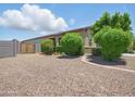 Spacious front yard featuring gravel landscaping and mature trees, offering a serene outdoor space at 10236 W Wood St, Tolleson, AZ 85353