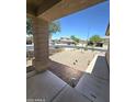 Inviting covered porch with a view of the low maintenance desert landscaping at 13037 W Laurel Ln, El Mirage, AZ 85335