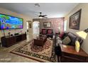 Comfortable living room with decorative wallpaper and plush leather sofas at 13037 W Laurel Ln, El Mirage, AZ 85335