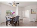 Bright dining area featuring wood-look tile floors, modern ceiling fan, and an elegant dining set at 1410 S Boulder St # A, Gilbert, AZ 85296