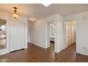 Bright entryway with tile flooring, white door, and views into other rooms at 14922 N 172Nd Dr, Surprise, AZ 85388