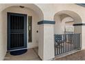 Inviting front porch with decorative arches and seating area, leading to the entry door at 14922 N 172Nd Dr, Surprise, AZ 85388