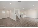 Open-concept living area with modern wood-style floors and staircase access at 1577 N Pueblo Dr, Apache Junction, AZ 85120