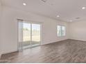 Bright and airy living room featuring wood-style floors and sliding glass door at 1577 N Pueblo Dr, Apache Junction, AZ 85120