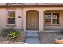 A close-up of a home's entrance with a decorative front door and gravel landscaping at 1710 S Parkcrest St, Gilbert, AZ 85295