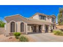Charming home featuring a wide covered carport and desert landscaping at 17853 W Pershing St, Surprise, AZ 85388