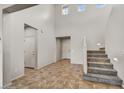 Spacious foyer featuring tile floors, a carpeted staircase and natural light at 1854 W Fetlock Trl, Phoenix, AZ 85085