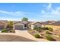 An aerial view showcasing a well-maintained home with solar panels and desert landscaping at 20082 N 272Nd Ln, Buckeye, AZ 85396