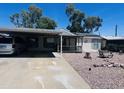 Charming home with covered parking, landscaping, and solar panels at 2011 N 26Th Cir, Mesa, AZ 85213