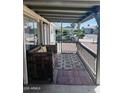 Inviting covered porch with bench seating and outdoor rug at 2011 N 26Th Cir, Mesa, AZ 85213
