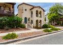 Charming two-story home featuring arched entryways, balconies, and landscaping at 2854 N Claire Dr, Buckeye, AZ 85396